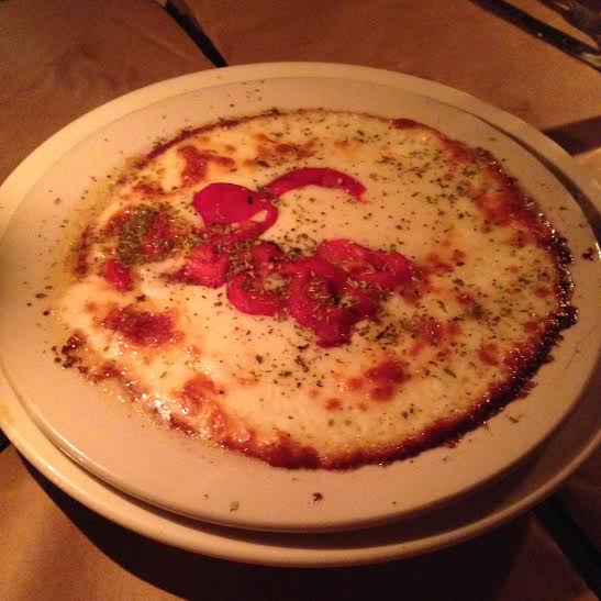 Argentine provolone cheese cooked on the grill with olive oil and roasted red pepper.